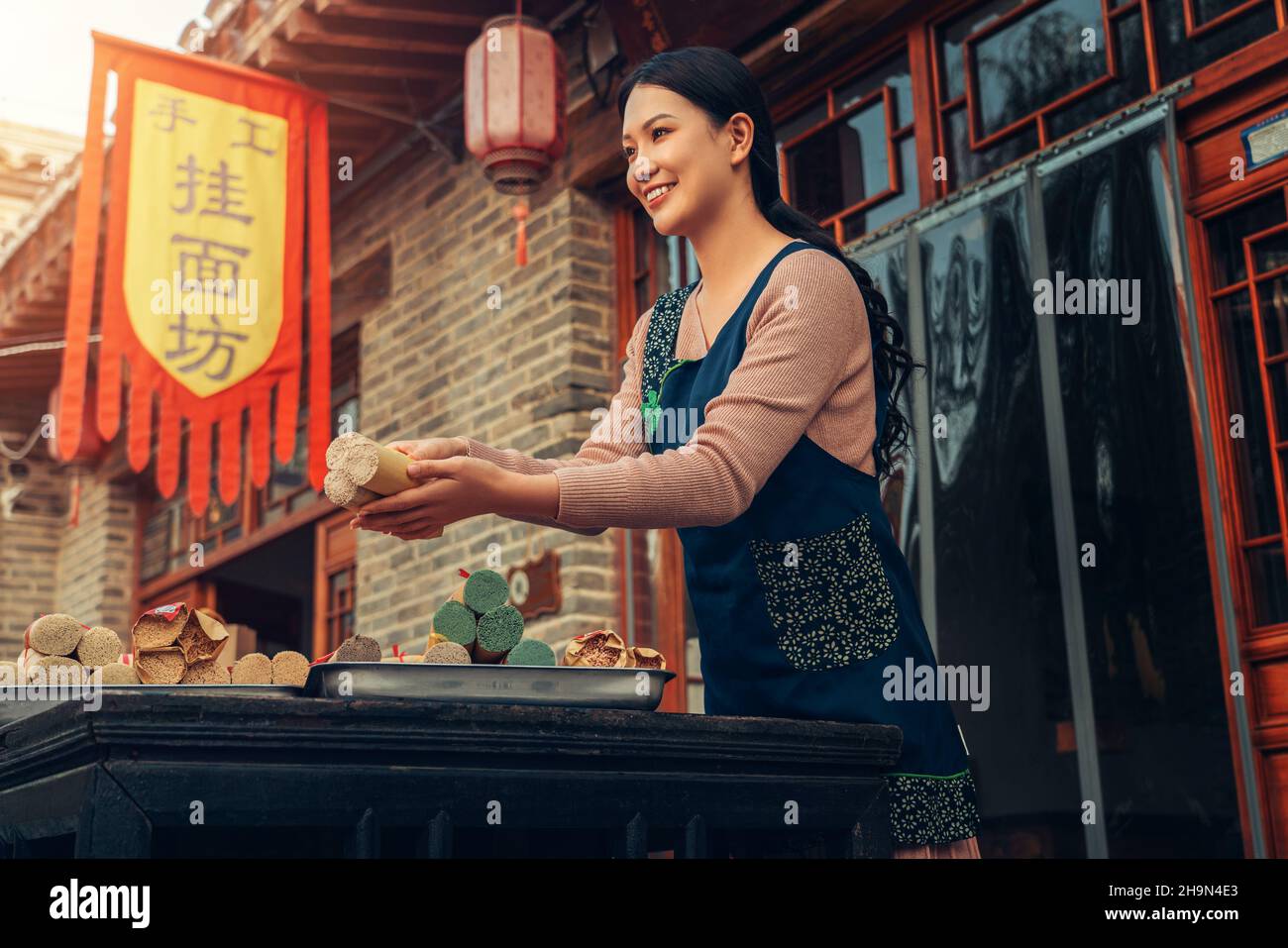 The enthusiasm of the waiter selling noodles Stock Photo