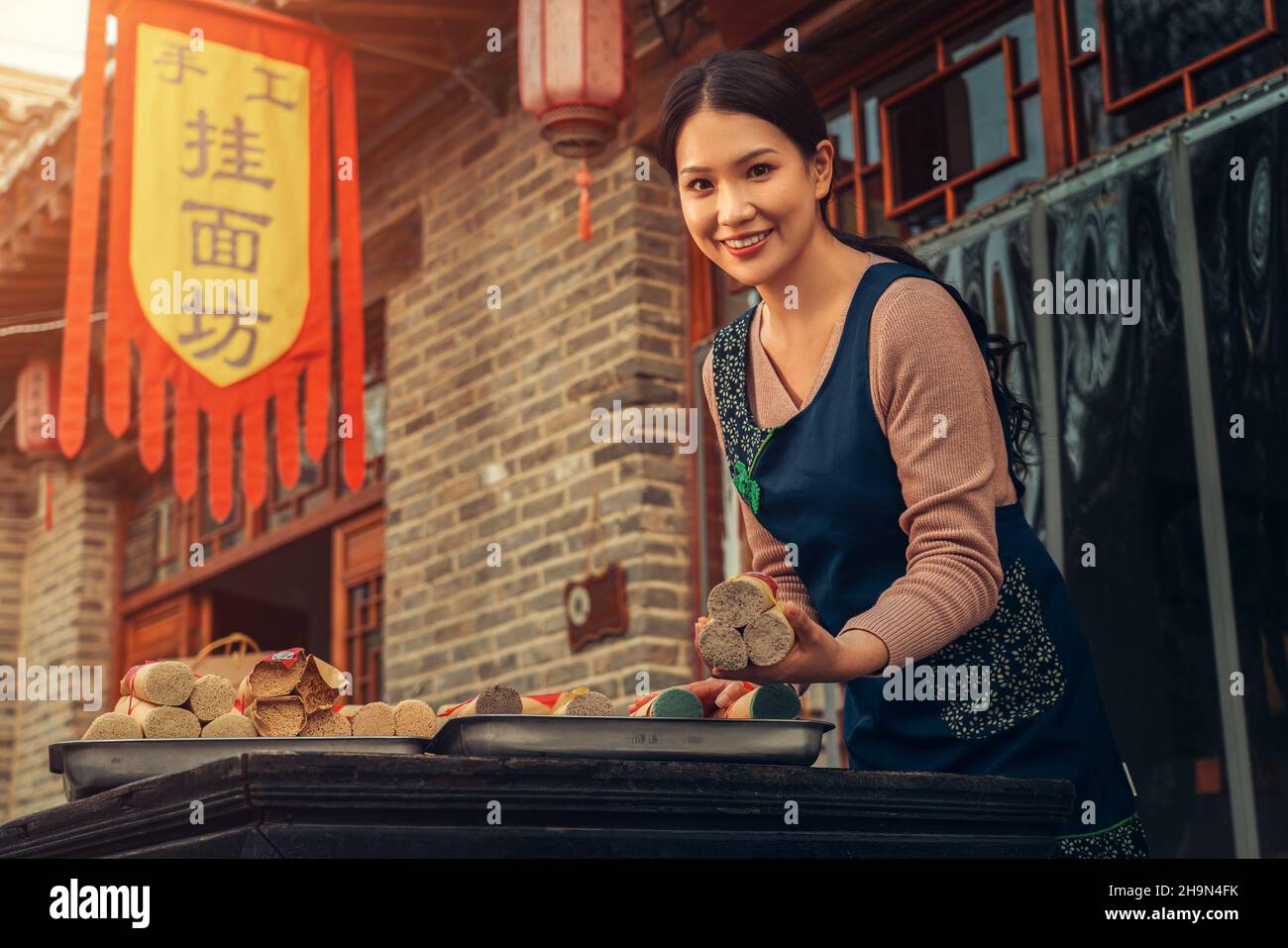 The enthusiasm of the waiter selling noodles Stock Photo