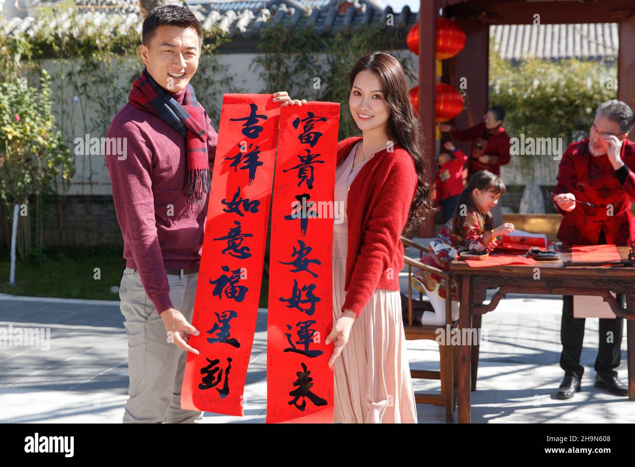 Happy family write Spring Festival couplets to celebrate the New Year