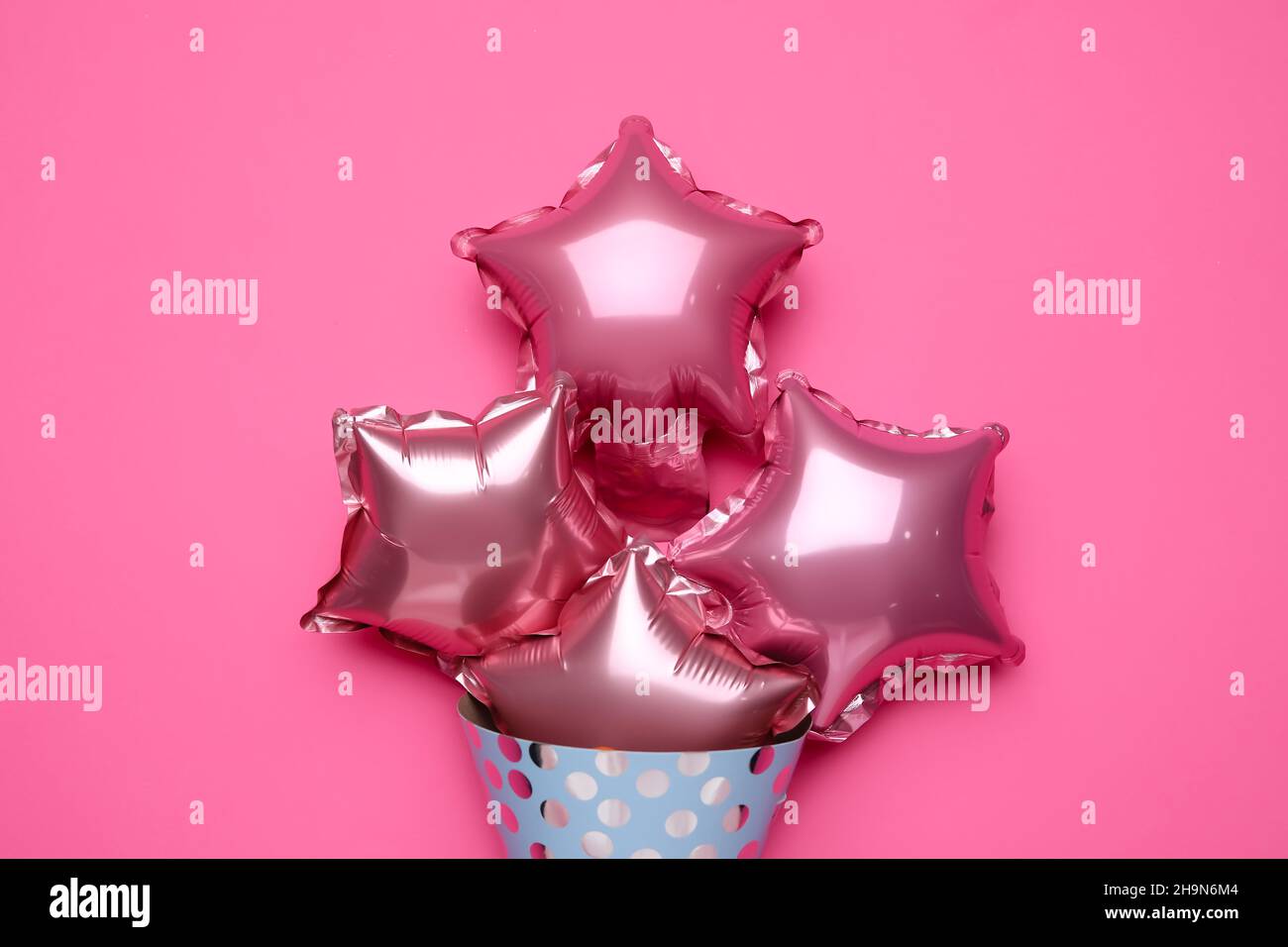 Beautiful balloons and party hat on pink background Stock Photo - Alamy
