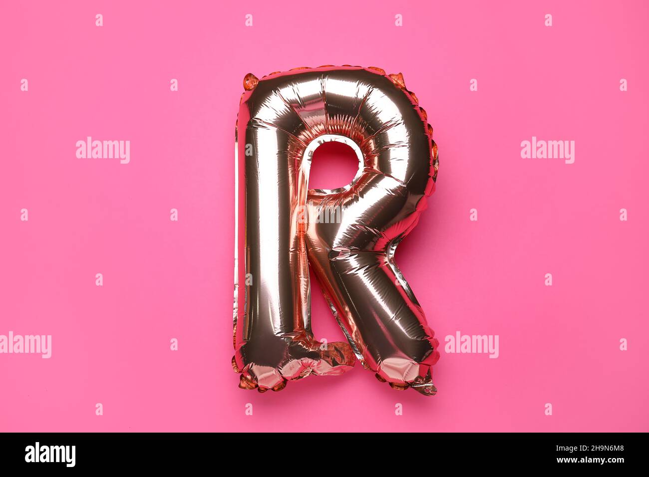 Balloon in shape of letter R on pink background Stock Photo - Alamy