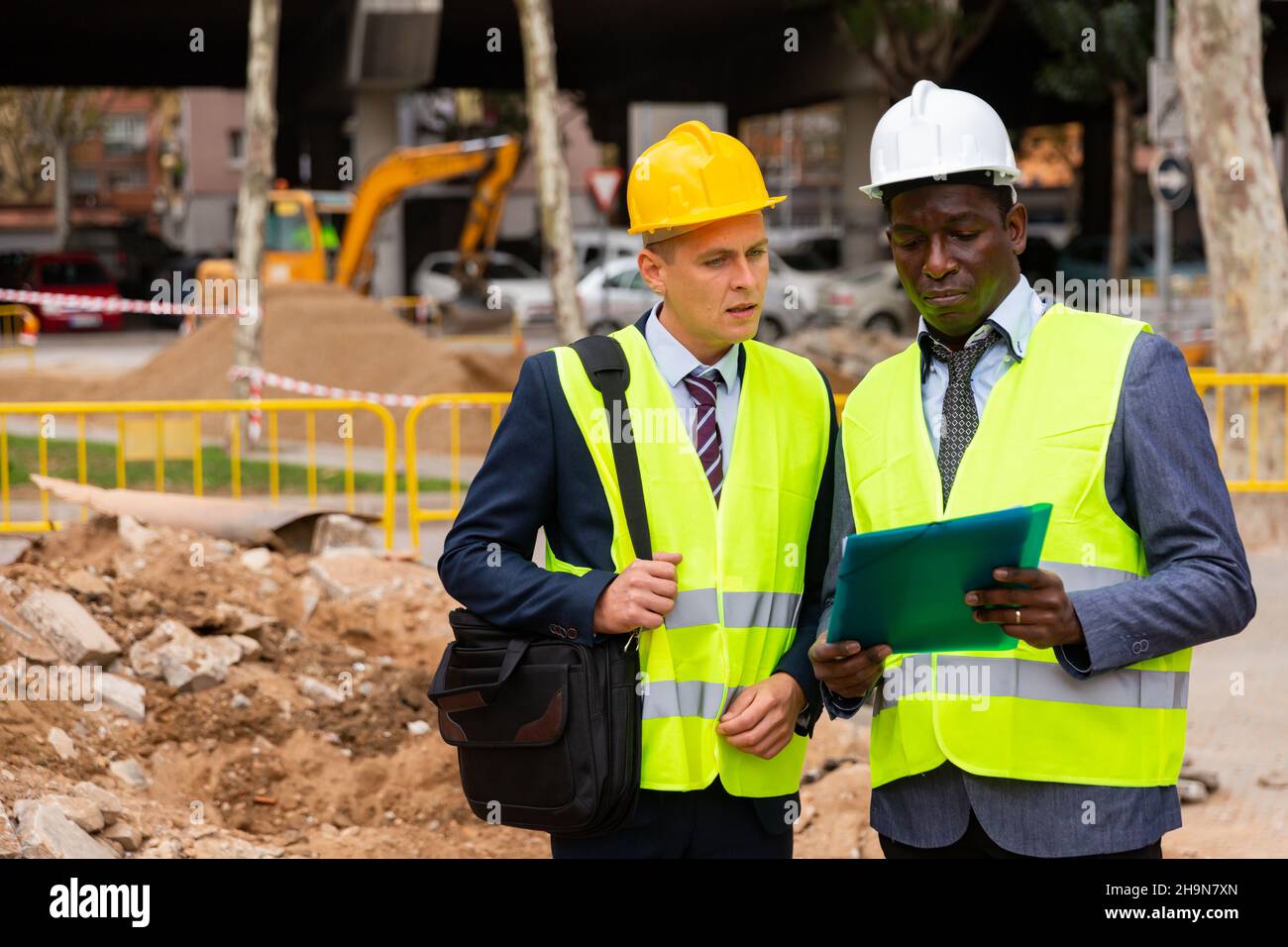 Two workers are studying a folder with important working papers Stock ...