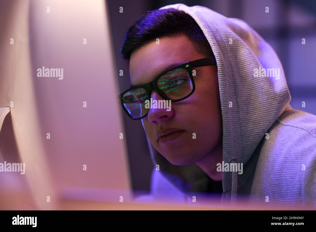 Hacker using computer in dark room Stock Photo - Alamy