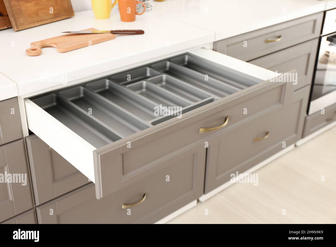 Opened kitchen drawer and utensils in room Stock Photo Alamy