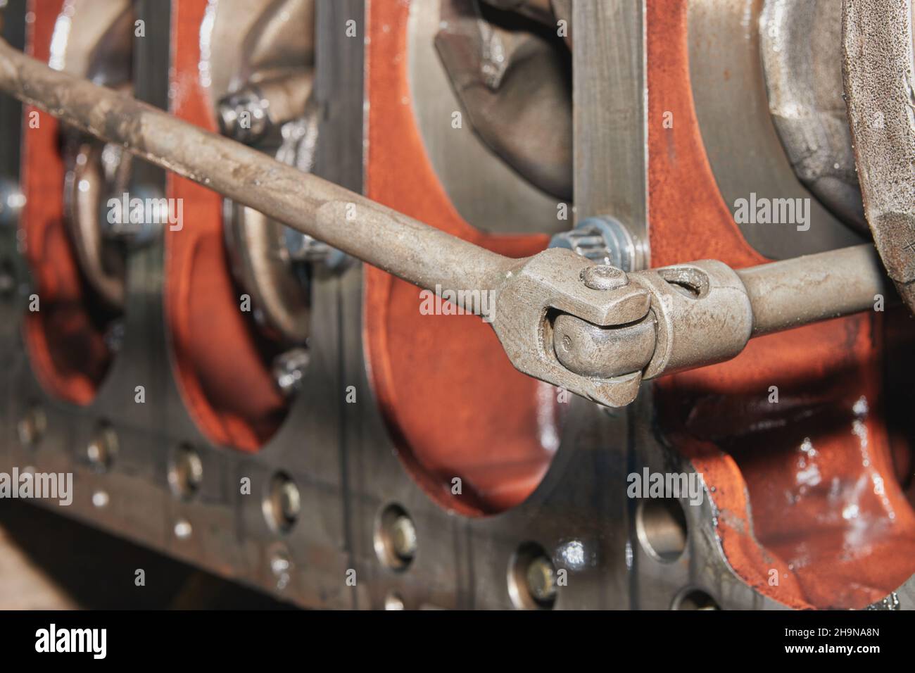 Car Mechanic or Auto Mechanic Use Breaker Bar Loosen Bolt of Crankshaft