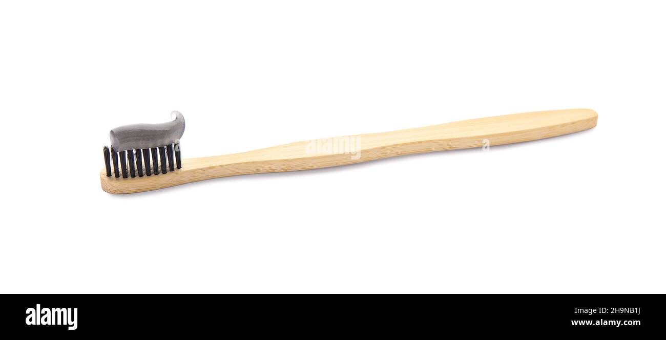 Bamboo brush with black tooth paste on white background Stock Photo - Alamy