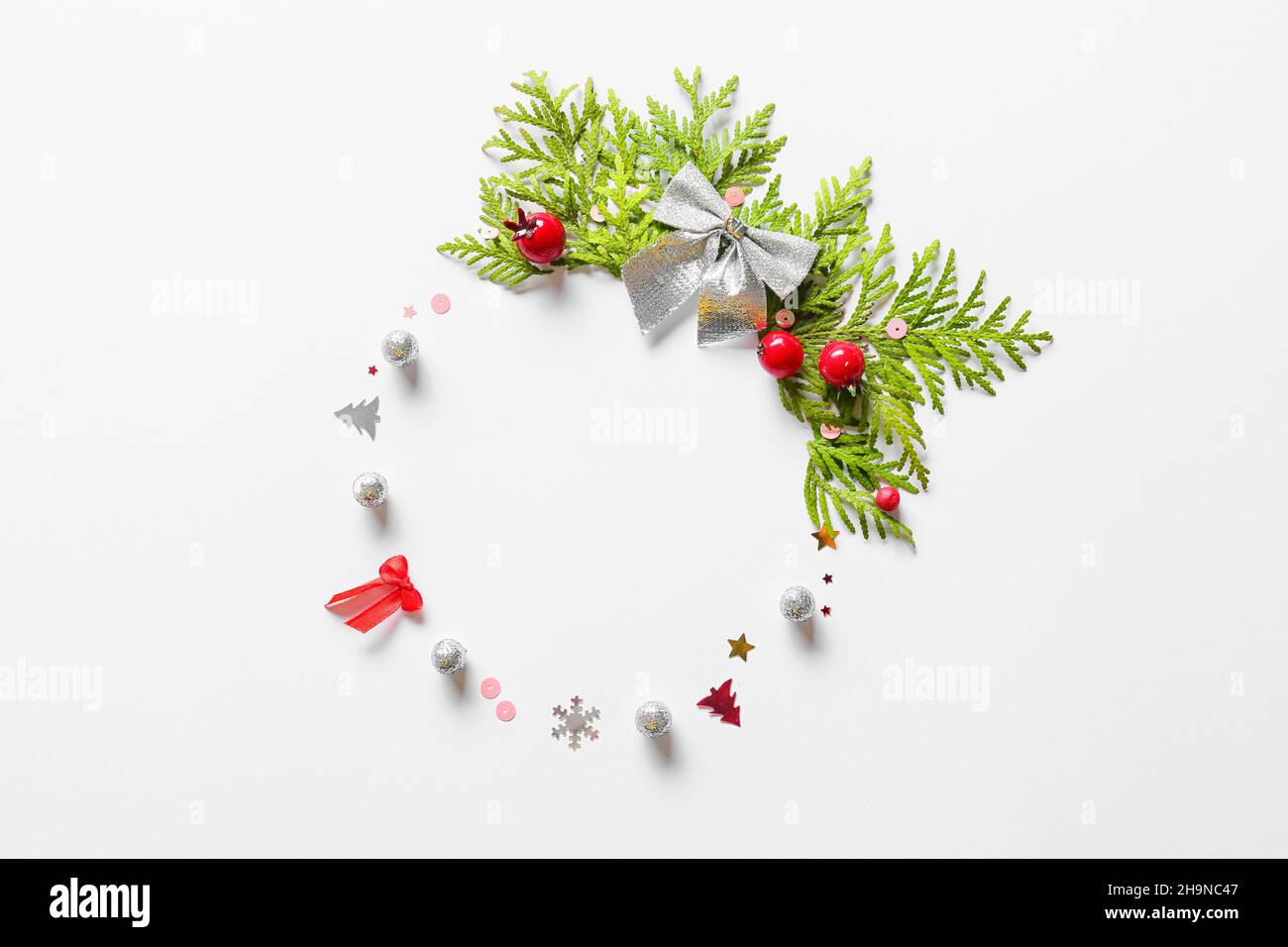 Beautiful wreath made of fir branches and Christmas decor on light ...