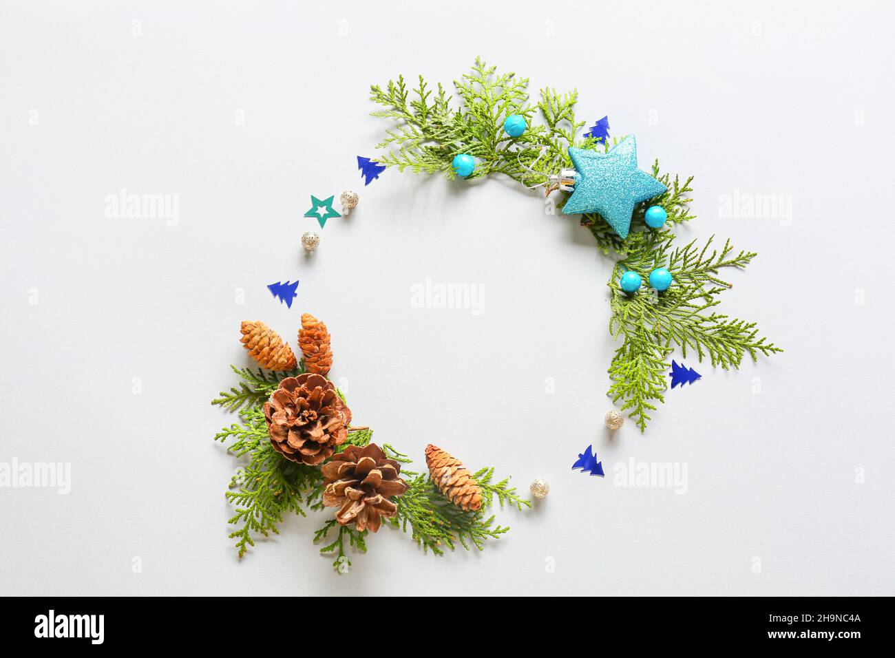 Beautiful wreath made of fir branches and Christmas decor on light ...
