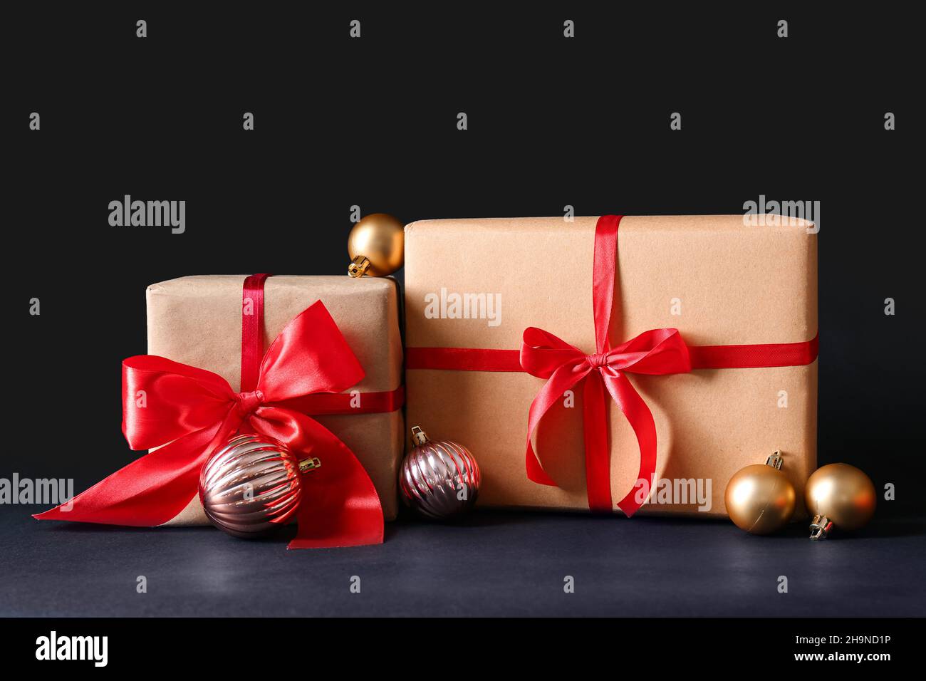 Beautiful Christmas gift boxes and balls on black background Stock ...