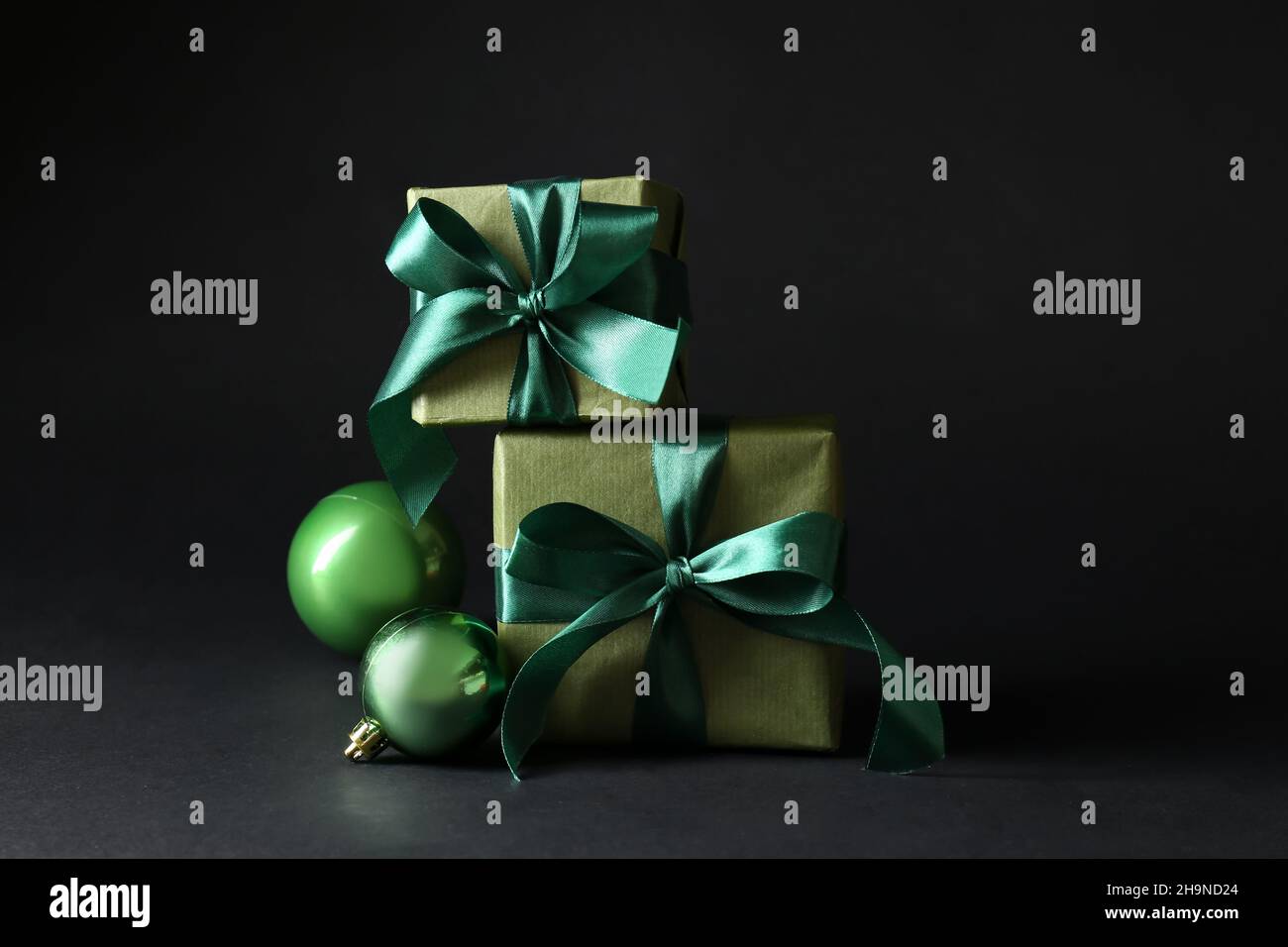Beautiful Christmas gift boxes and balls on black background Stock ...