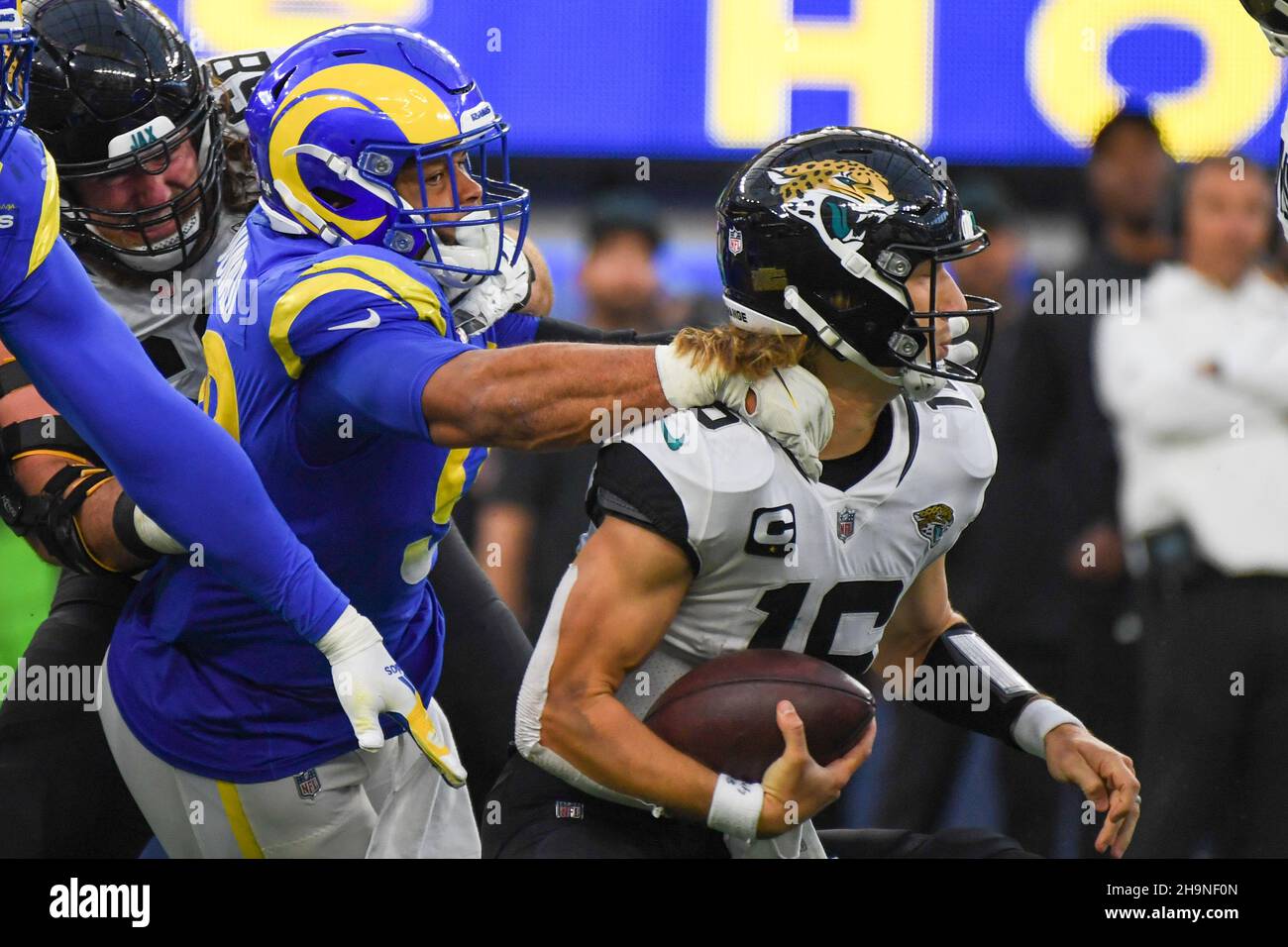 Jacksonville Jaguars quarterback Trevor Lawrence (16) is tackled by Los Angeles Rams defensive end Aaron Donald (99) during an NFL game against the Lo Stock Photo