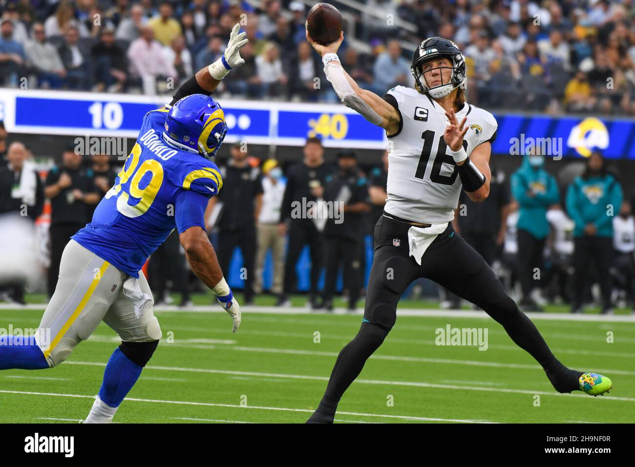 Jacksonville Jaguars quarterback Trevor Lawrence (16) is pressured by Los Angeles Rams defensive end Aaron Donald (99) during an NFL game against the Stock Photo