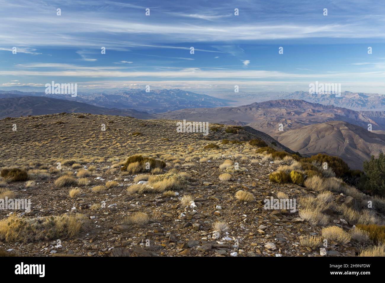 Distant Aerial Landscape View from Wildrose Mountain Peak across Death Valley National Park in California with Distant Sierra Nevada Mountains Skyline Stock Photo