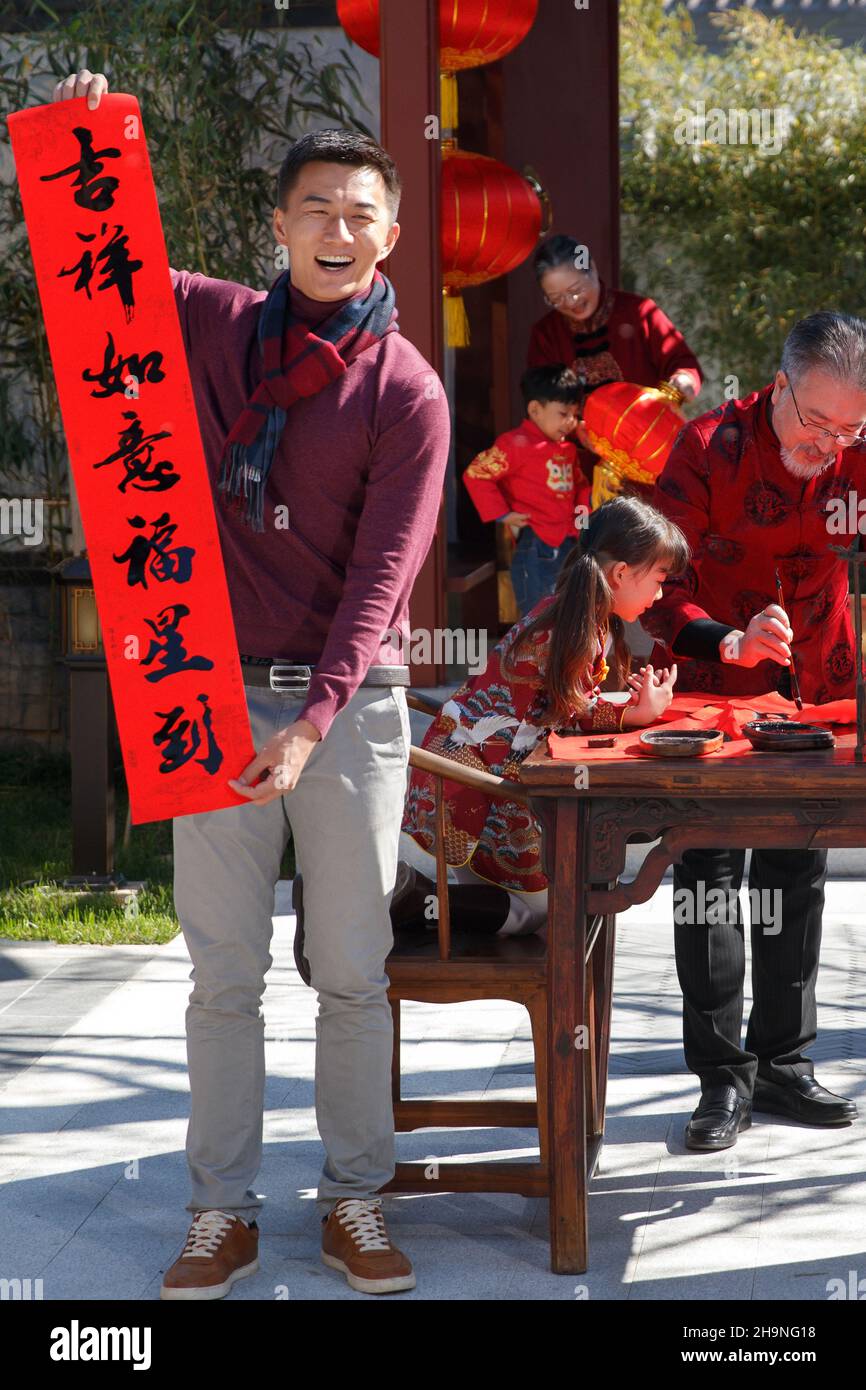 Happy family write Spring Festival couplets to celebrate the New Year ...