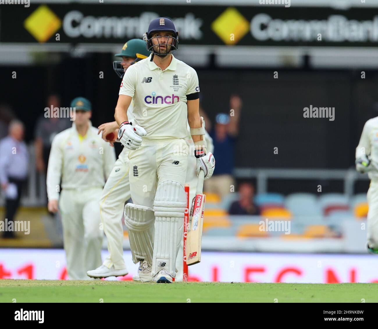 Mark Wood edges the ball and is caught by Marcus Harris. Wood exits the field. Stock Photo