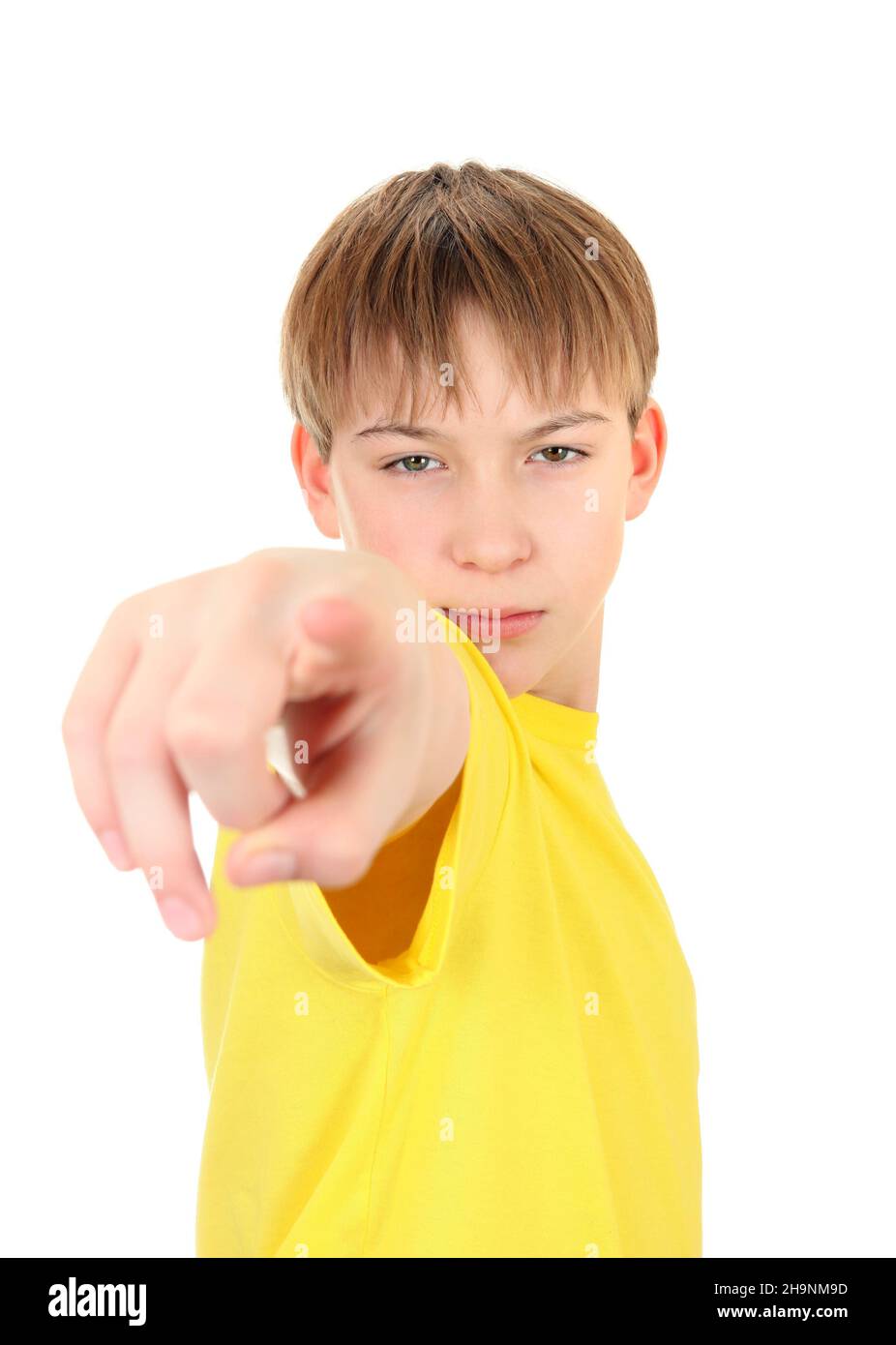 Serious Boy pointing at You Isolated on the White Background Stock Photo