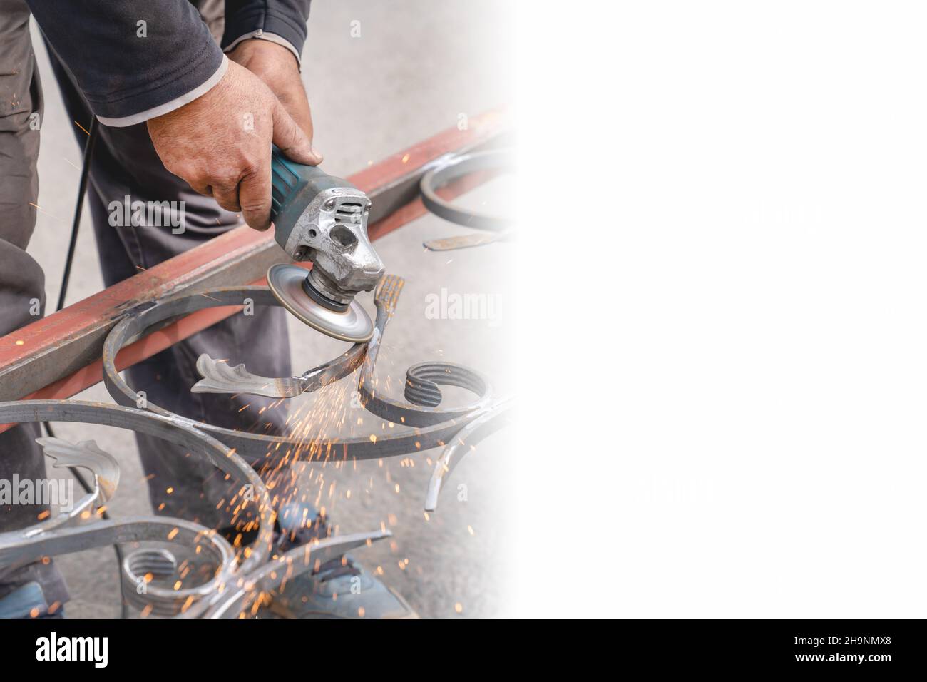 Metal grinding with angle grinder. Sparks fly on the sides. Male hand