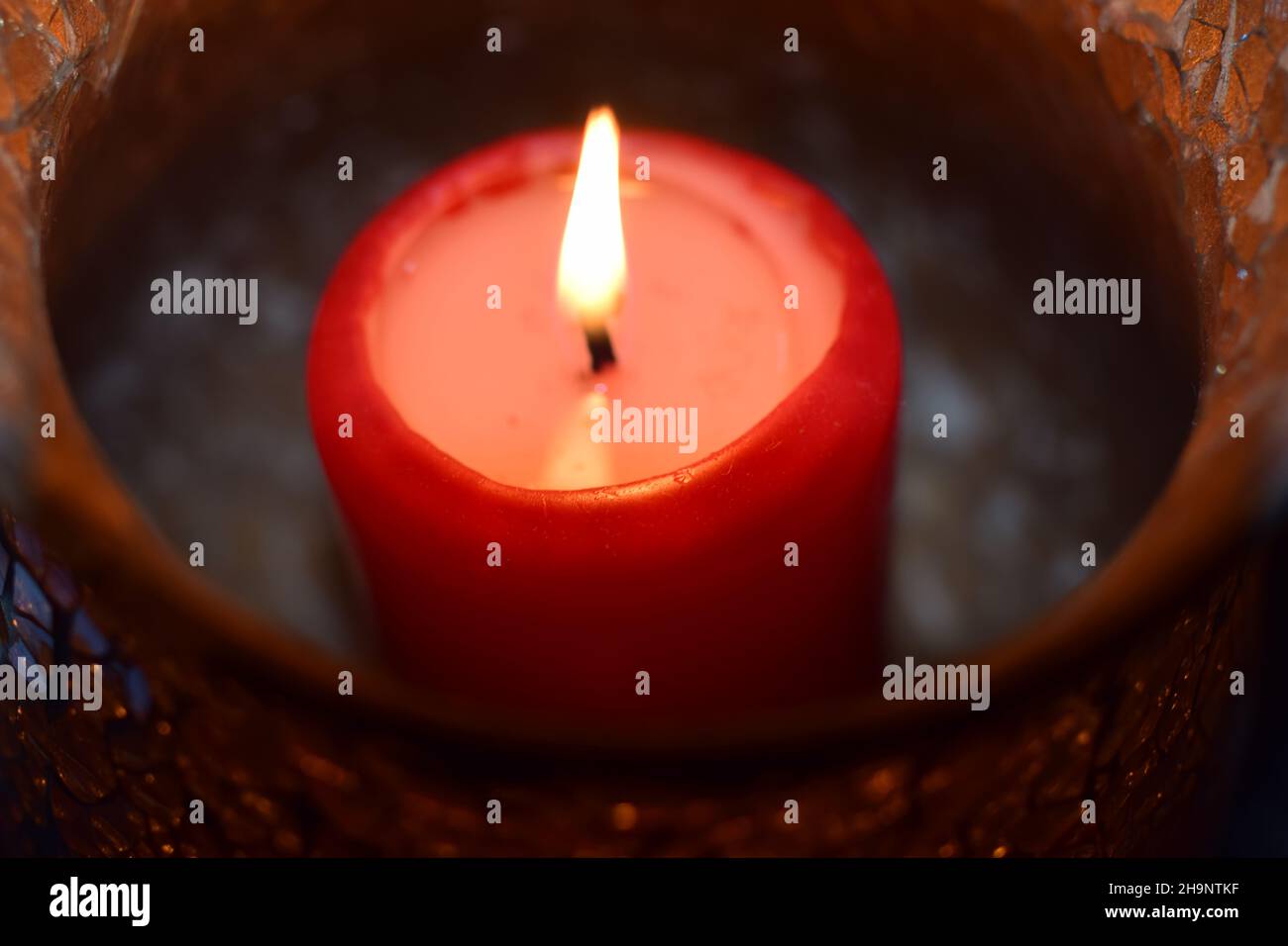 Burning red candle as a close up Stock Photo Alamy