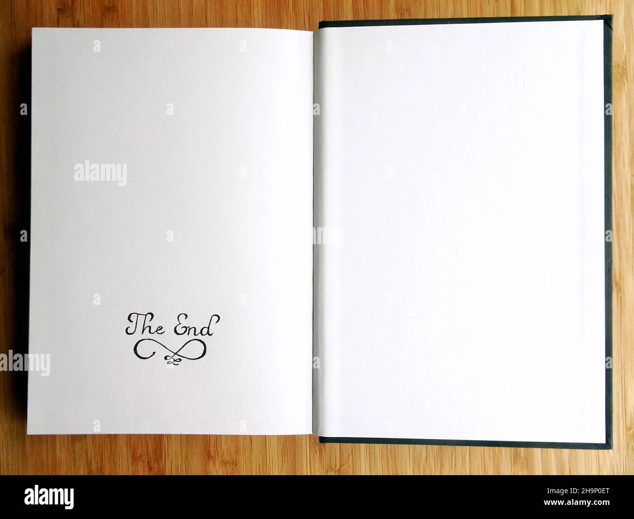 A sketchbook open on the last page with 'The End' written by pencil Stock Photo