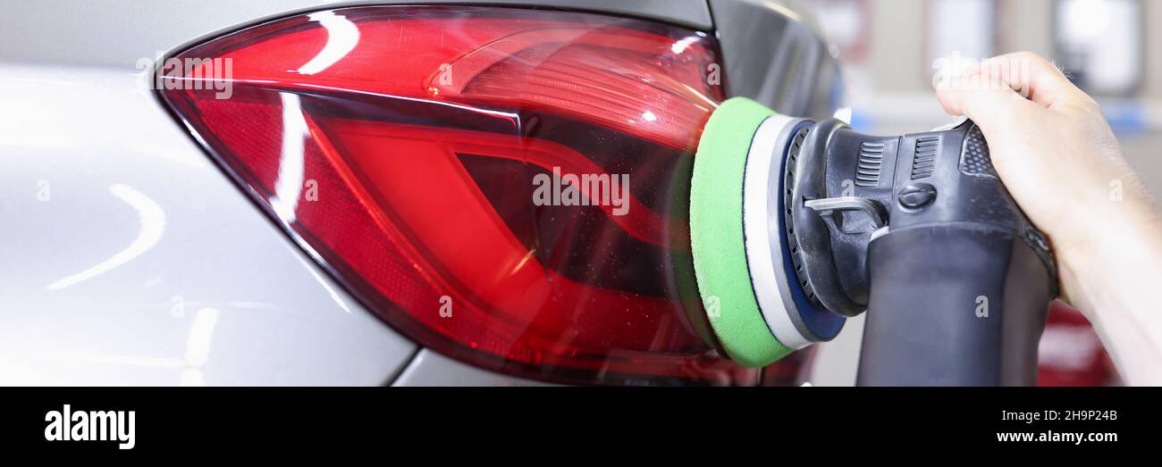 Detailing and polishing of car tail light on car closeup Stock Photo