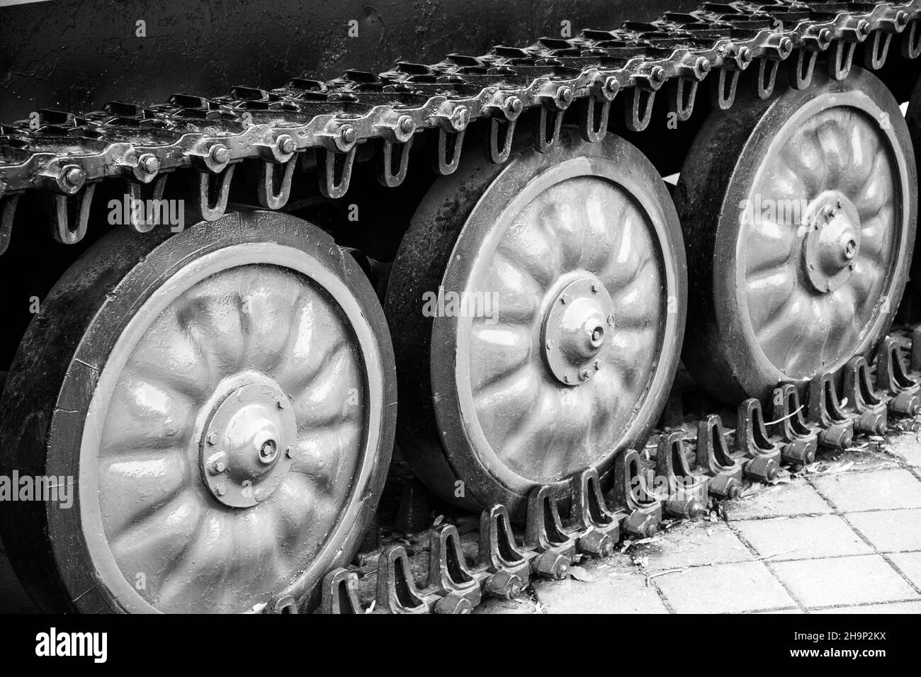 detail of a military self-propelled vehicle on a caterpillar track close-up black and white photo Stock Photo