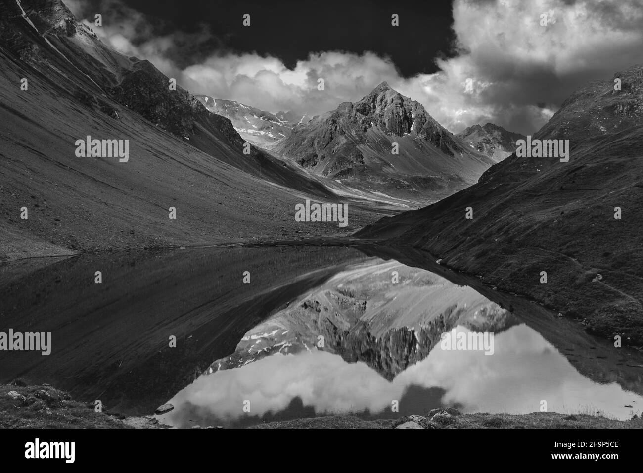 The photo shows the picturesque Aelpli lake in Arosa, Switzerland. Black and white conversion. Stock Photo