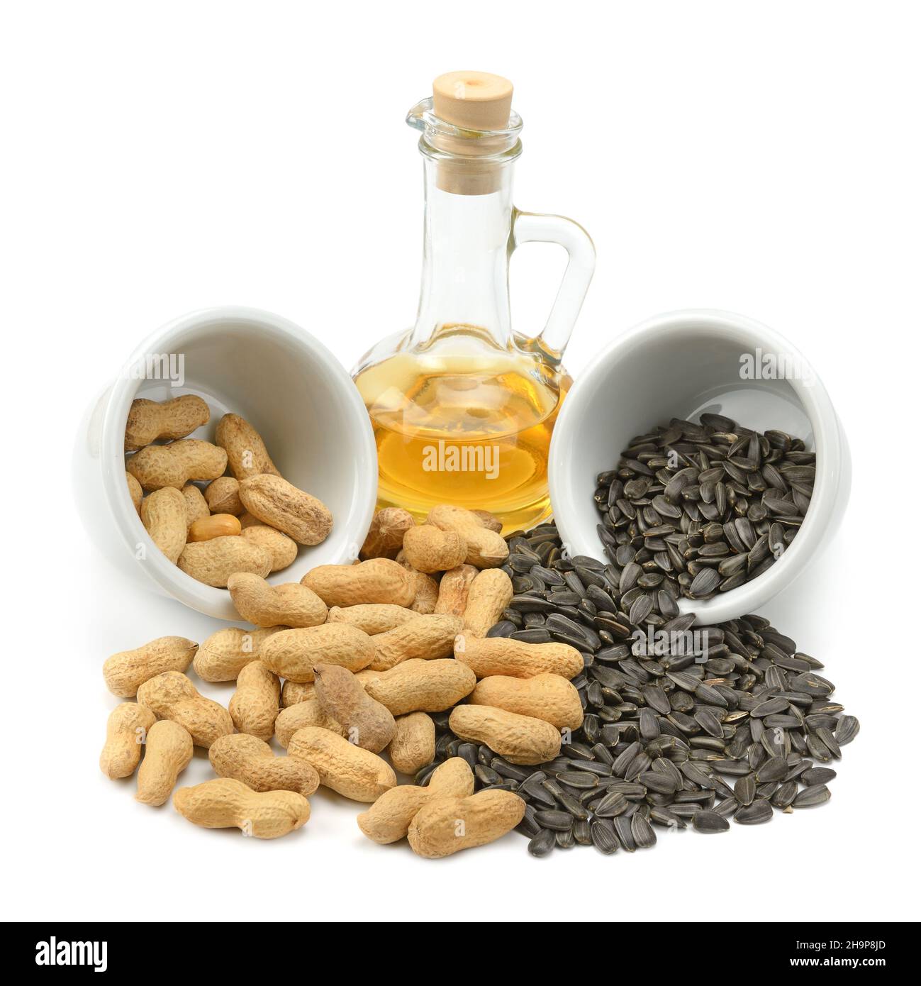 Sunflower seeds, peanuts and oil isolated on a white background Stock