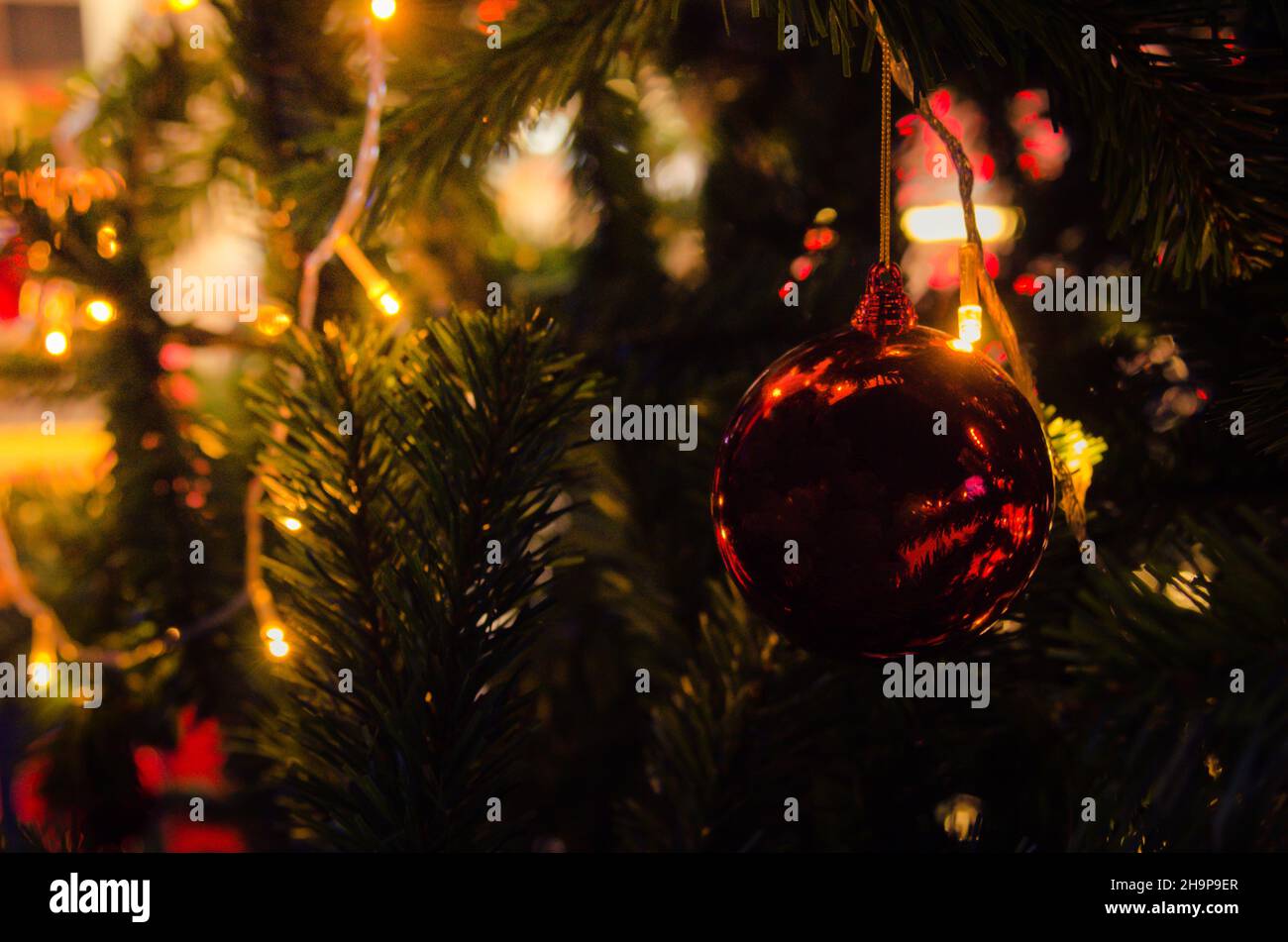 Christmas tree decorations with lights and red balls Stock Photo