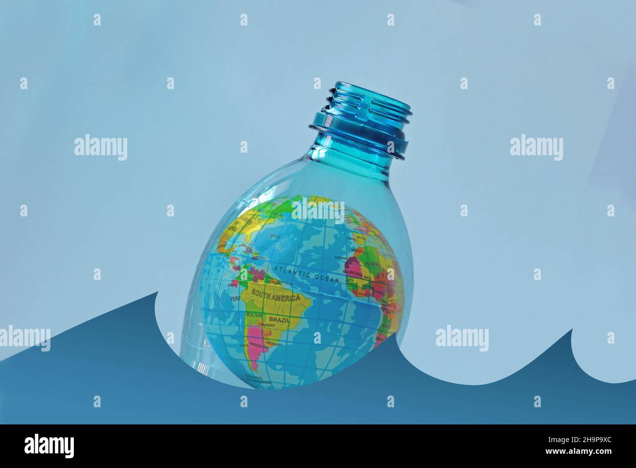 Earth in a plastic bottle floating on water Concept of ecology