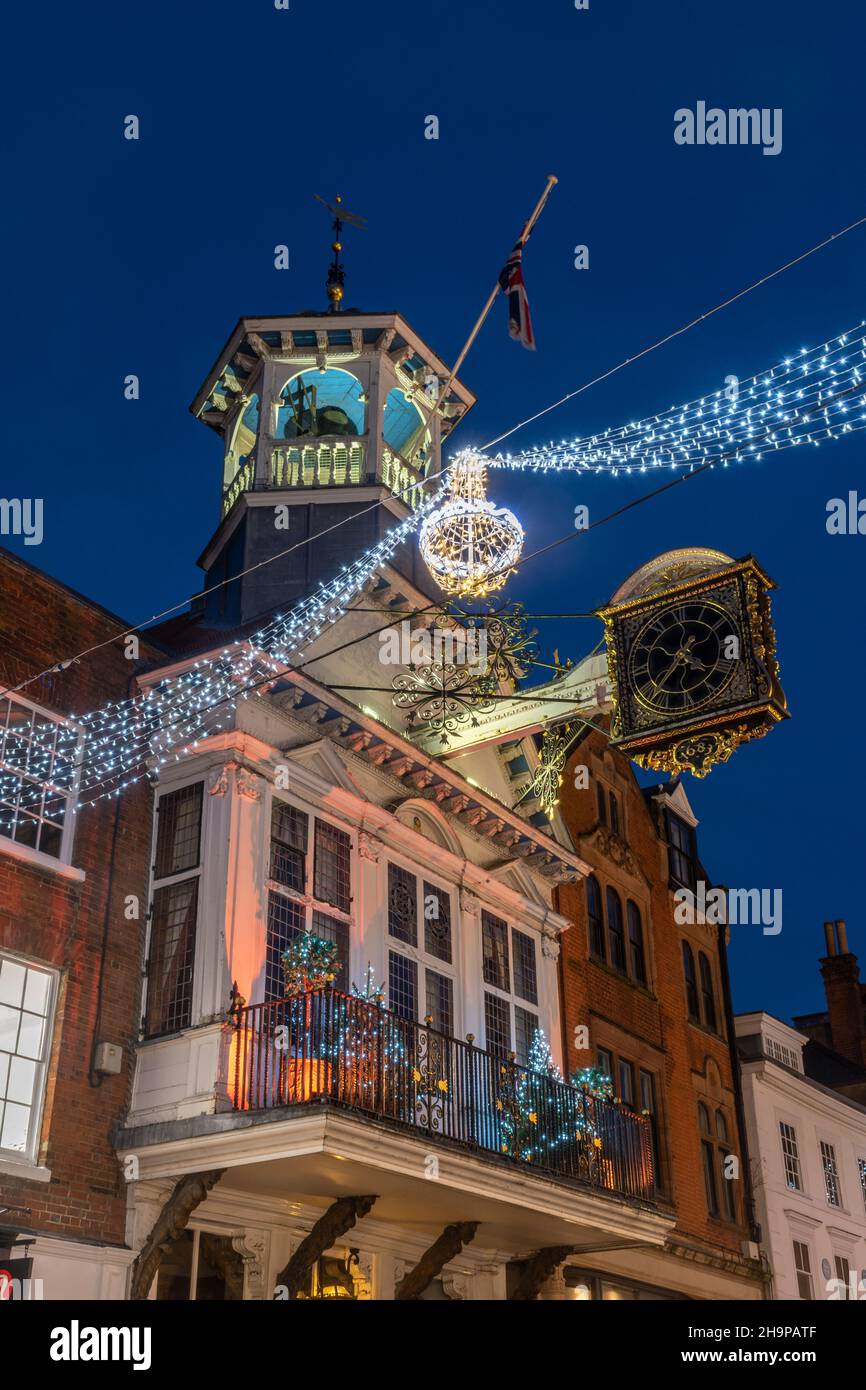 Christmas lights and decorations in Guildford High Street, the Guildhall and clock in the town centre at night in December 2021, Surrey, England, UK Stock Photo