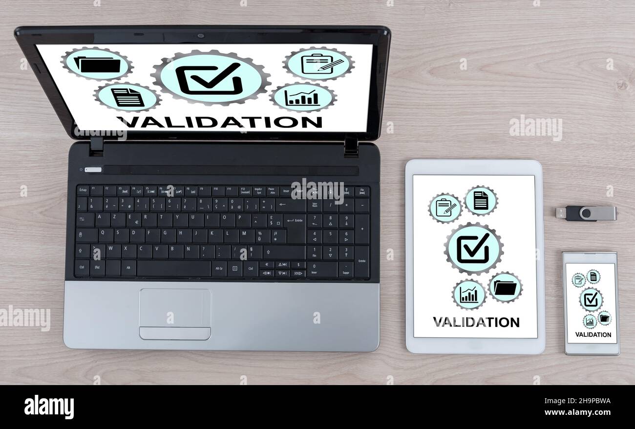 Validation concept shown on different information technology devices Stock Photo