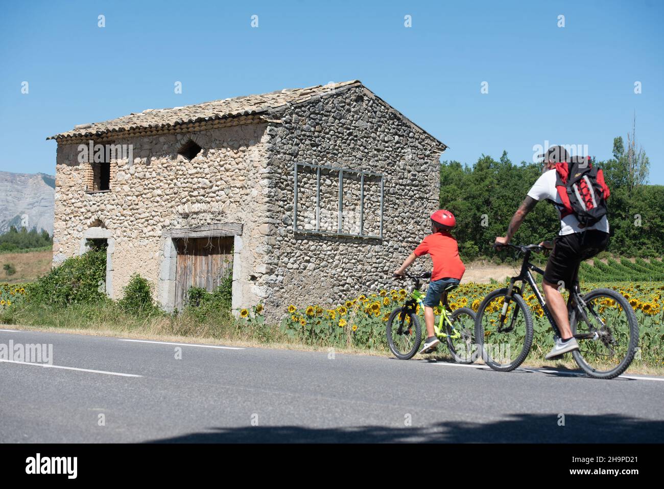 Bike ride in the Drome department (south-eastern France). Man and little boy, father and son, on the B road D539 near Chatillon-en-Diois Stock Photo