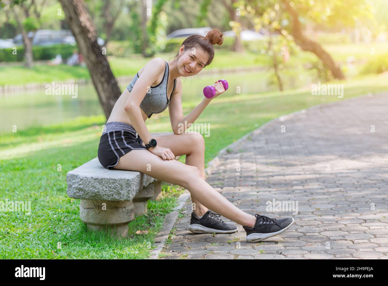 Slimming healthy women in sportswear teen cute happy enjoy fit and firm weight in the park Stock Photo