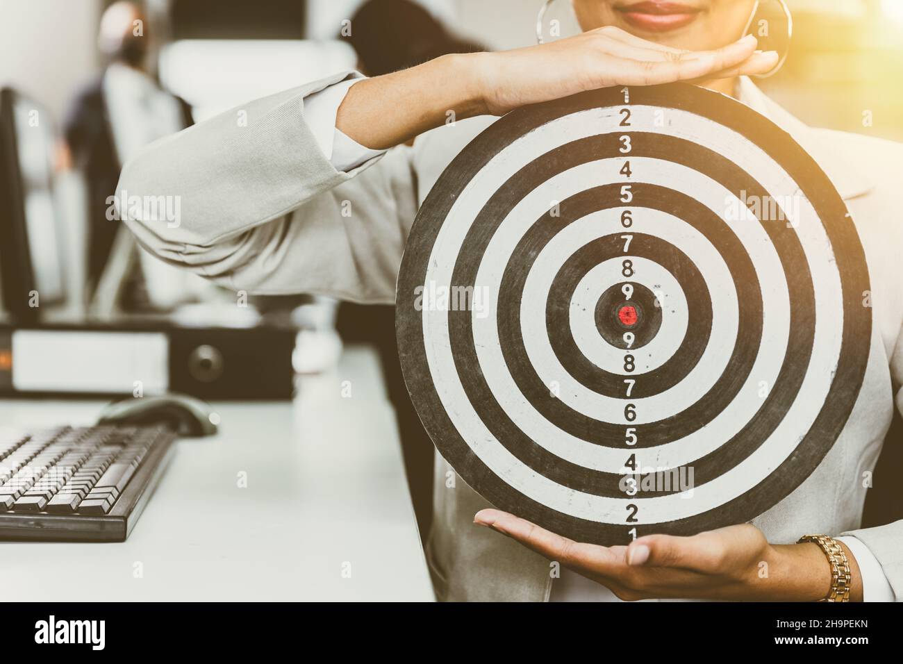 Business target concept, office women with dartboard for aim center target highest hit point. Stock Photo