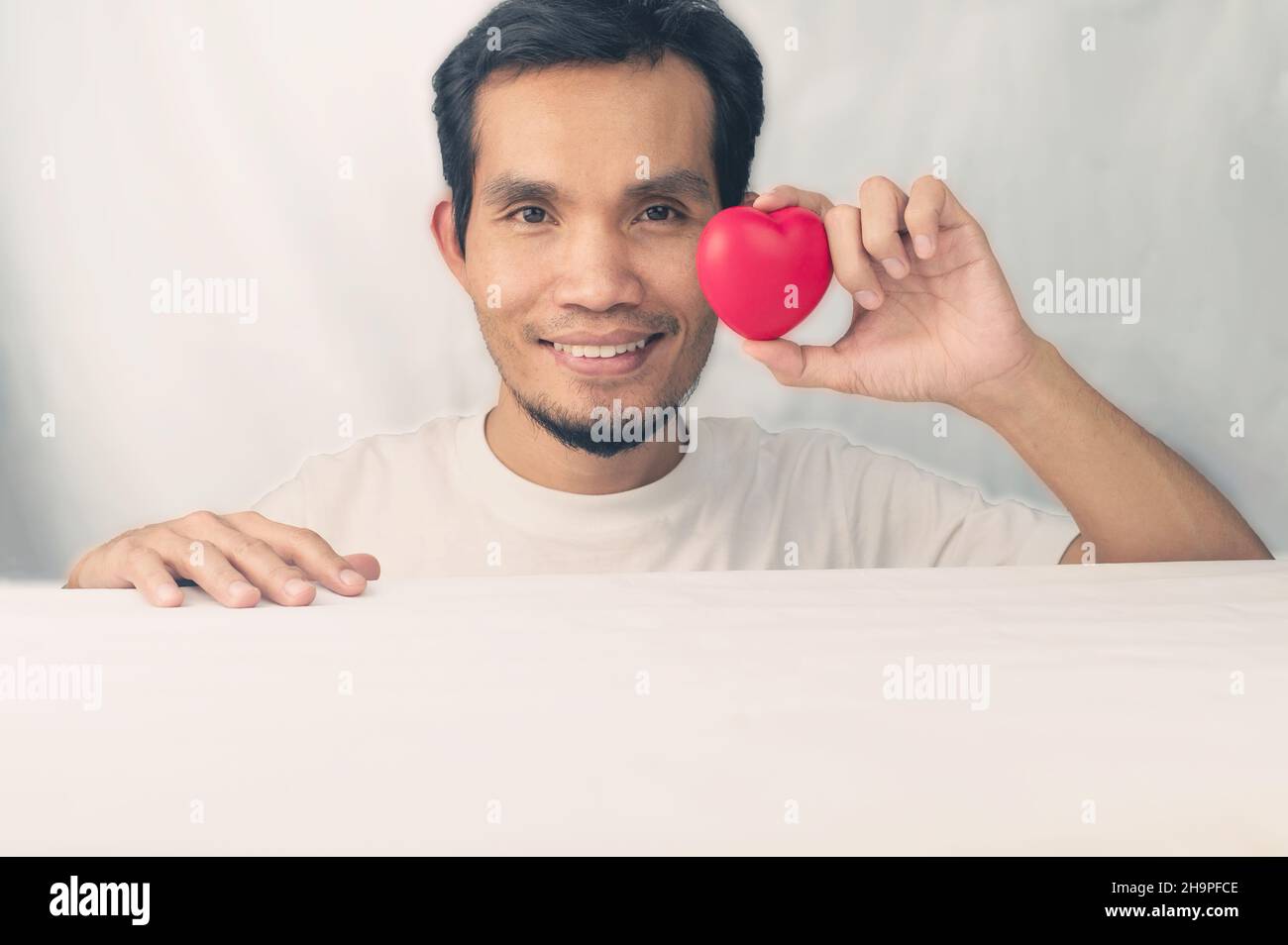 Happy man holding red heart ,world Heart day, Red heart Stock Photo - Alamy