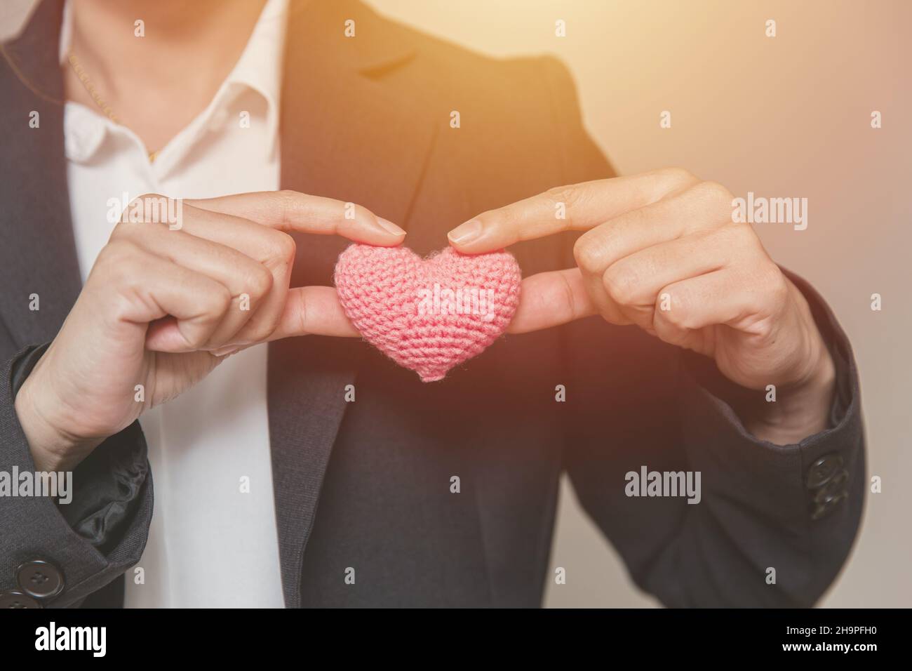 Business employee with heart for customer care relationship management and service mind concept Stock Photo