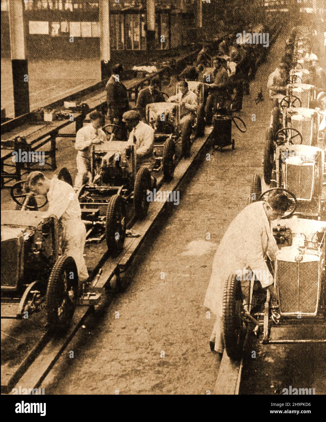 A production line scene in the old MG production works,.MG stands for Morris Garages - the initials pay homage to car manufacturer  William Morris. Morris who owned the garages where MG's founder Cecil Kimber originally worked. Stock Photo