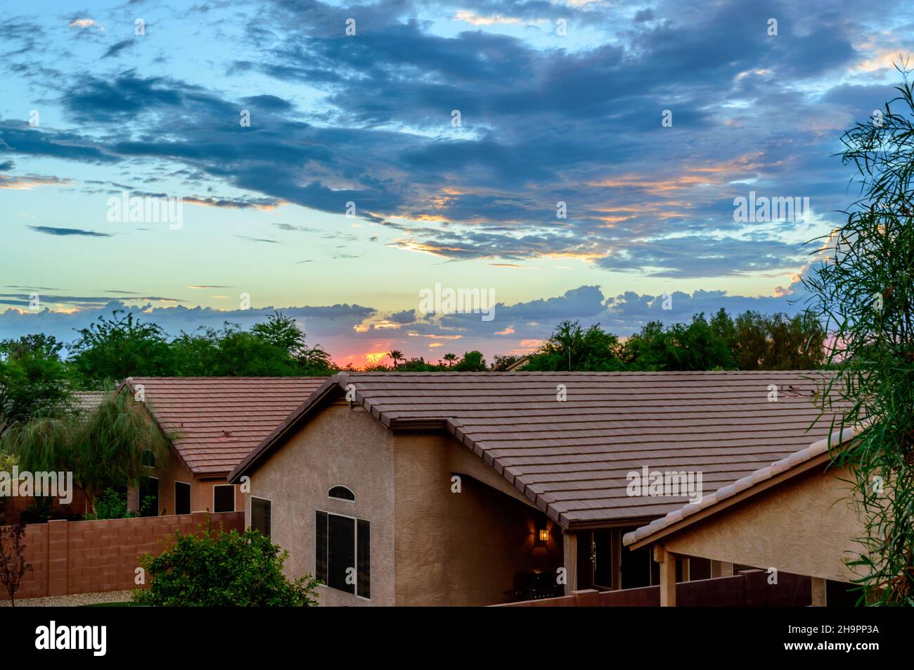 Rooftop view of Phoenix homes under a dramatic sunset sky Stock Photo