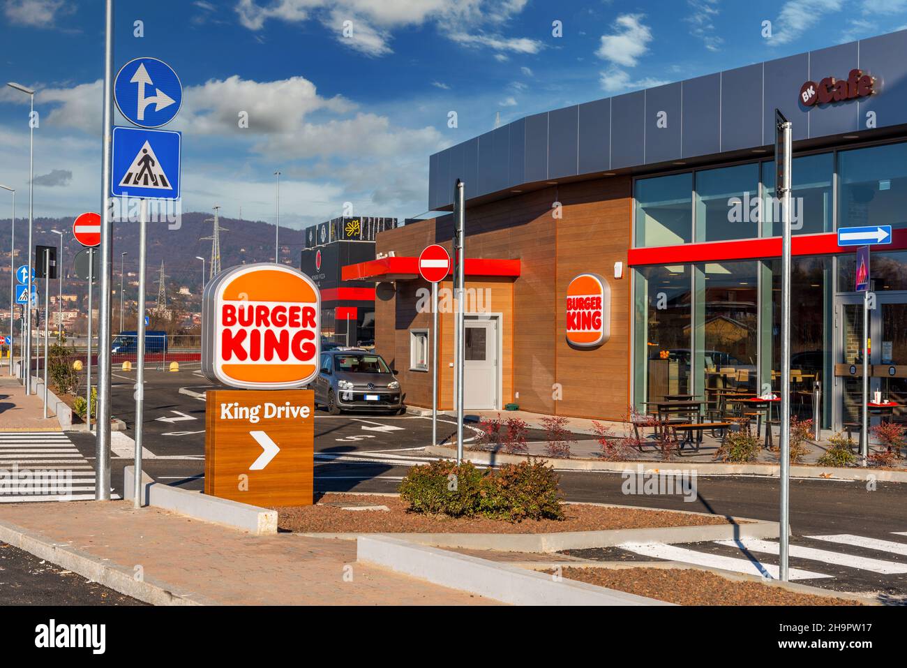 Moncalieri, Turin, Italy - December 6, 2021: King Drive of New Burger King Restaurant with in via Fortunato Postiglione, sign post with new logo on bl Stock Photo