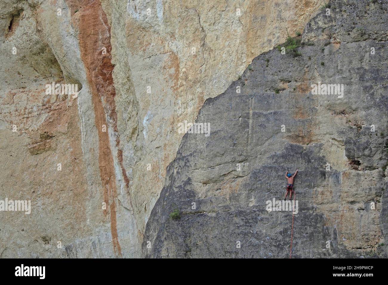 Climber on rope in rock face, steep face, rock plateau, mountaineering, steep face climber, climbing, rock climbing, roped down, roped up, climbing Stock Photo