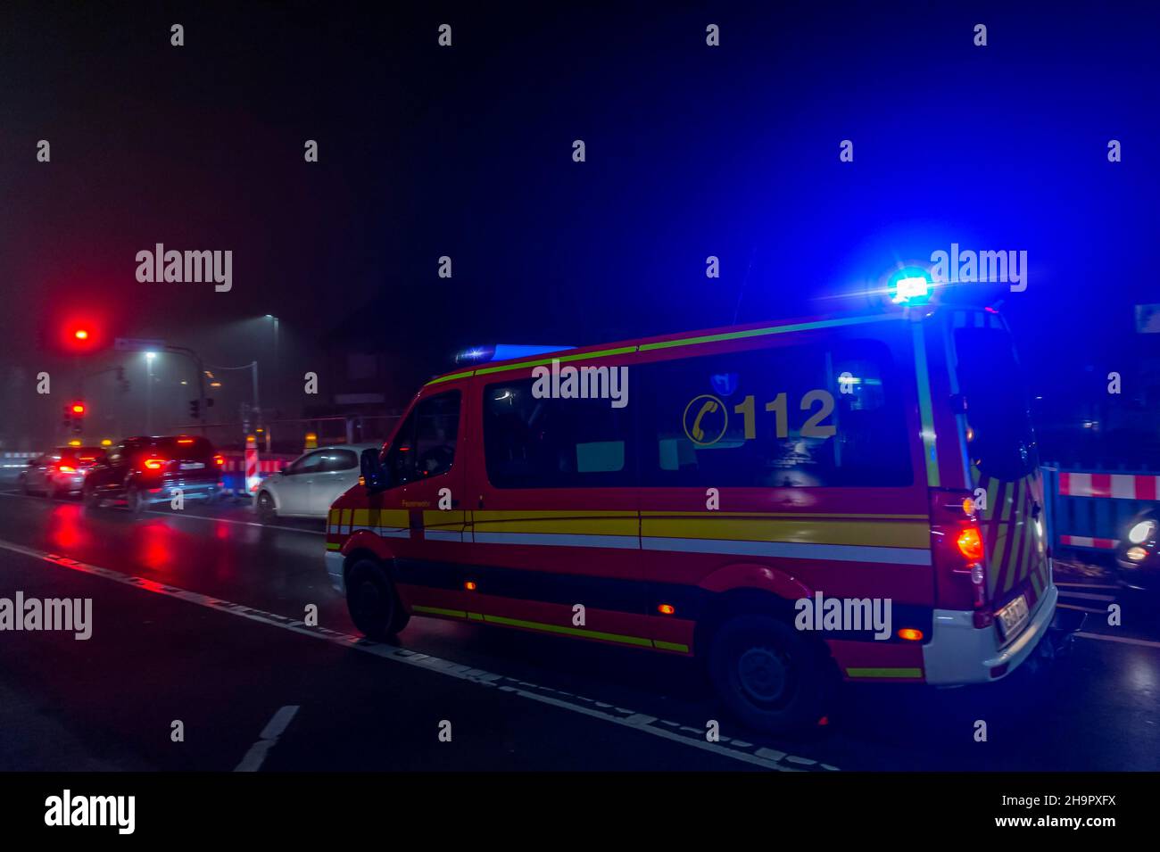 Fire brigade rescue vehicle on a road at night, Germany, North Rhine-Westphalia, Grevenbroich Stock Photo