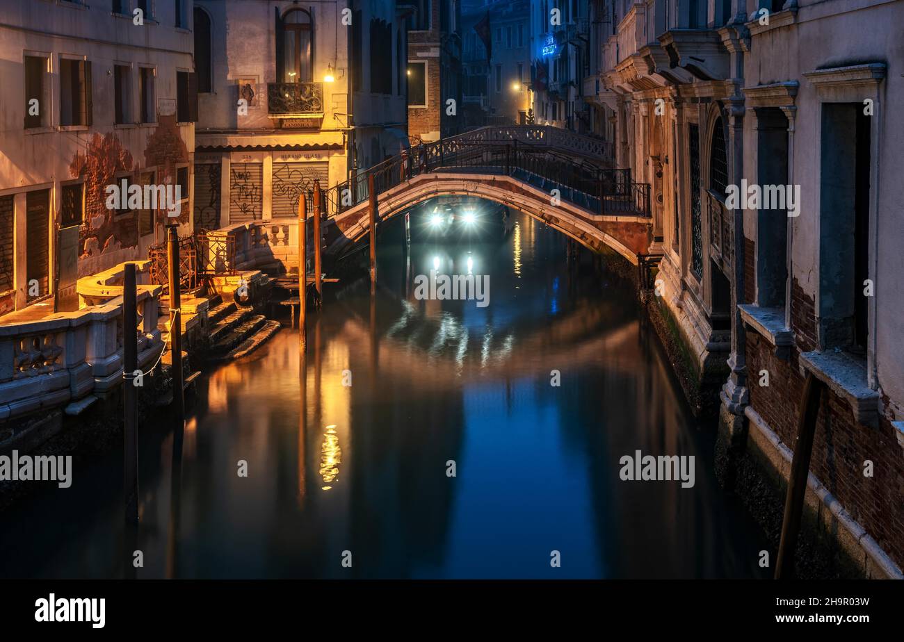 Night shot of a small water canal in the lagoon city, Venice, Italy Stock Photo