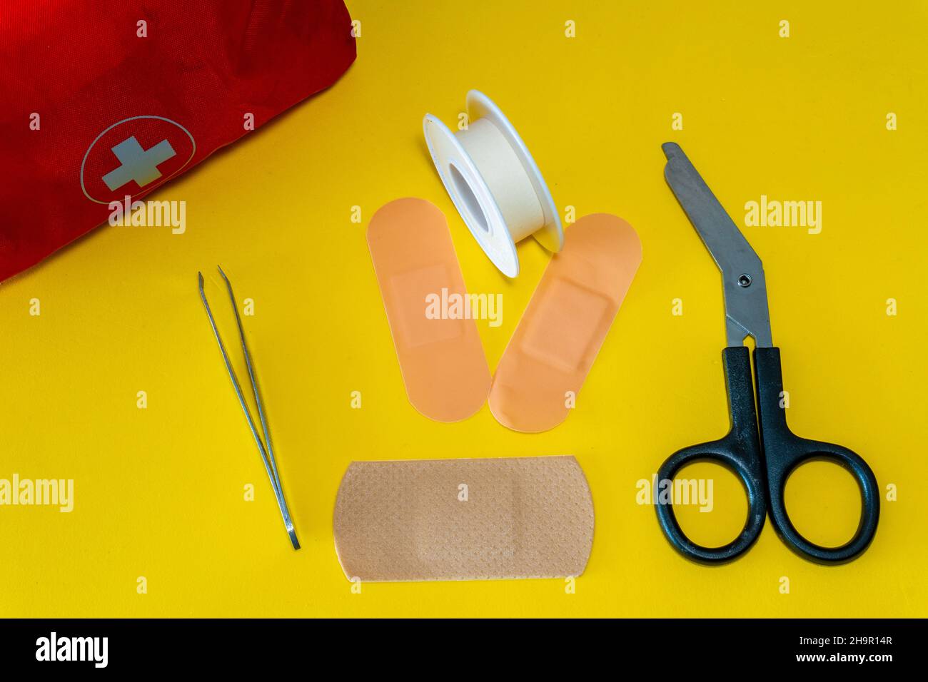 First aid kit on the yellow background Stock Photo