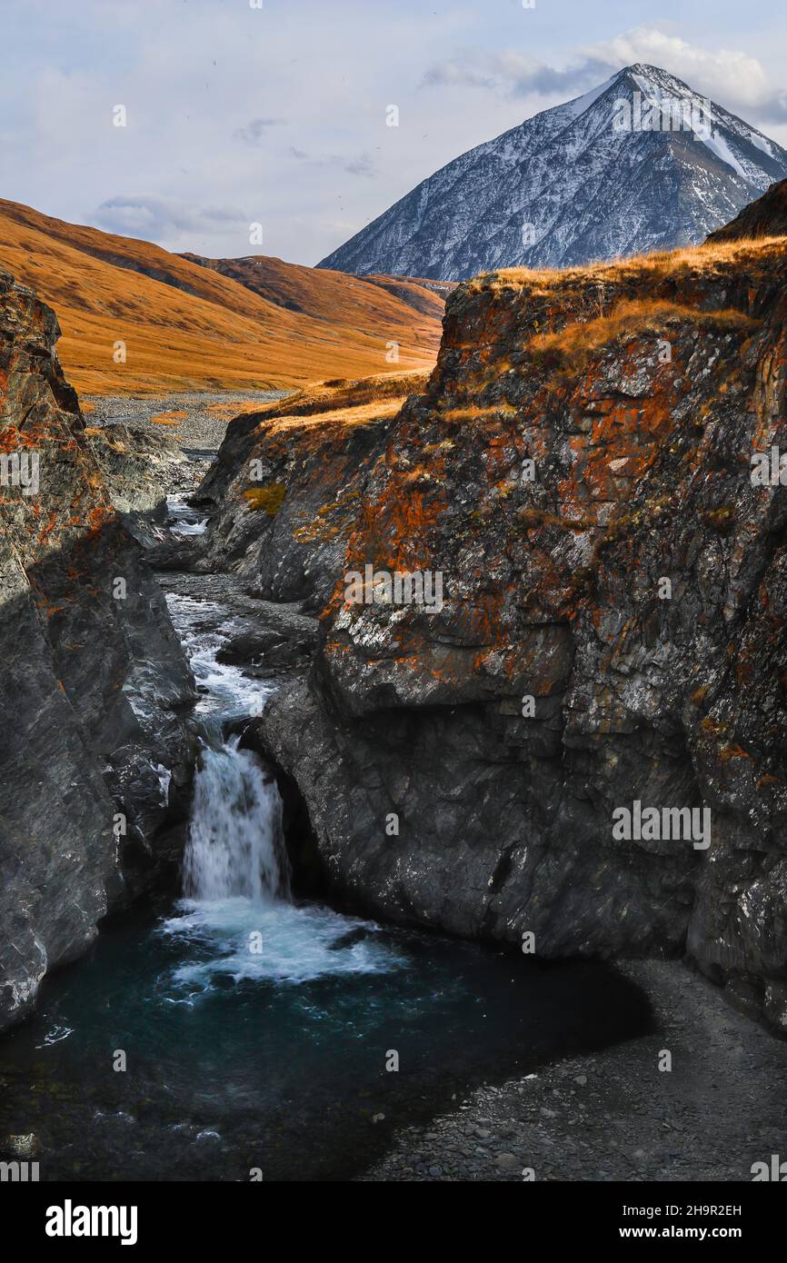 Putorana Plateau, a waterfall on the Grayling Stream. Mountain stream on a  cloudy day Stock Photo - Alamy