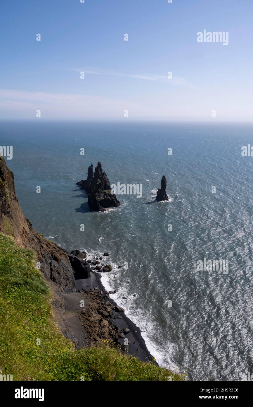 Cliff, rocks in the water, at Reynisfjara beach, Dyrholaey, South Iceland, Iceland Stock Photo