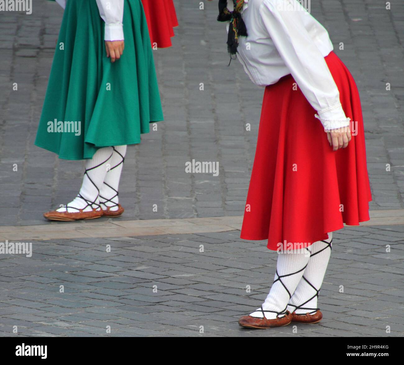 Group of people in traditional clothing doing a folk dance in Basque Country Stock Photo