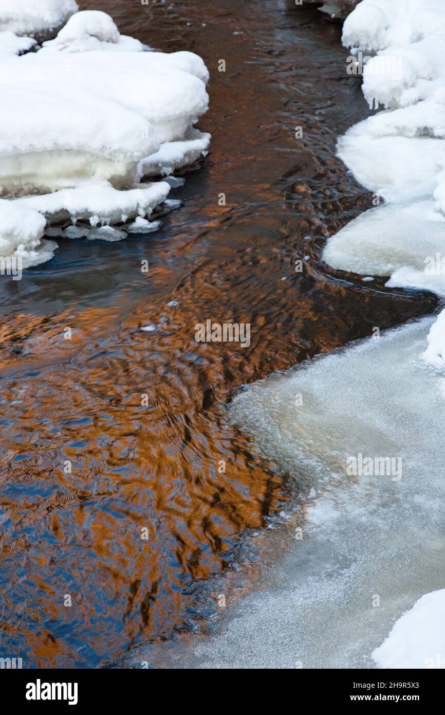 Creek With Ice And Snow And Reflections In The Water Stock Photo Alamy
