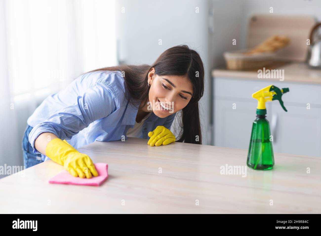 https://c8.alamy.com/comp/2H9R84C/cheerful-young-woman-cleaning-dining-table-at-kitchen-2H9R84C.jpg