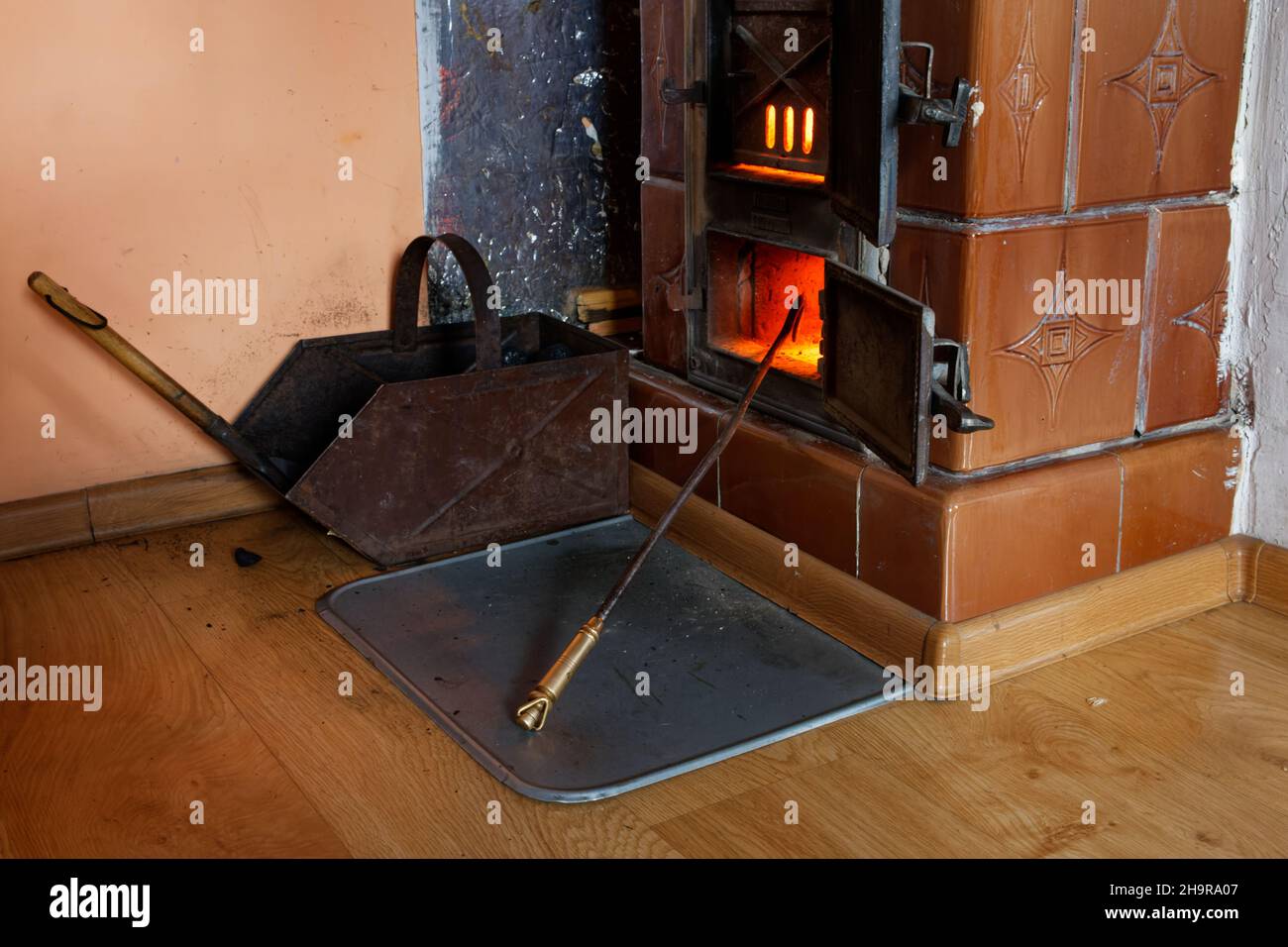Indoor coal fired furnace in teh apartment of an old tenement house, at fullblaze, on a cold winter day. Stock Photo