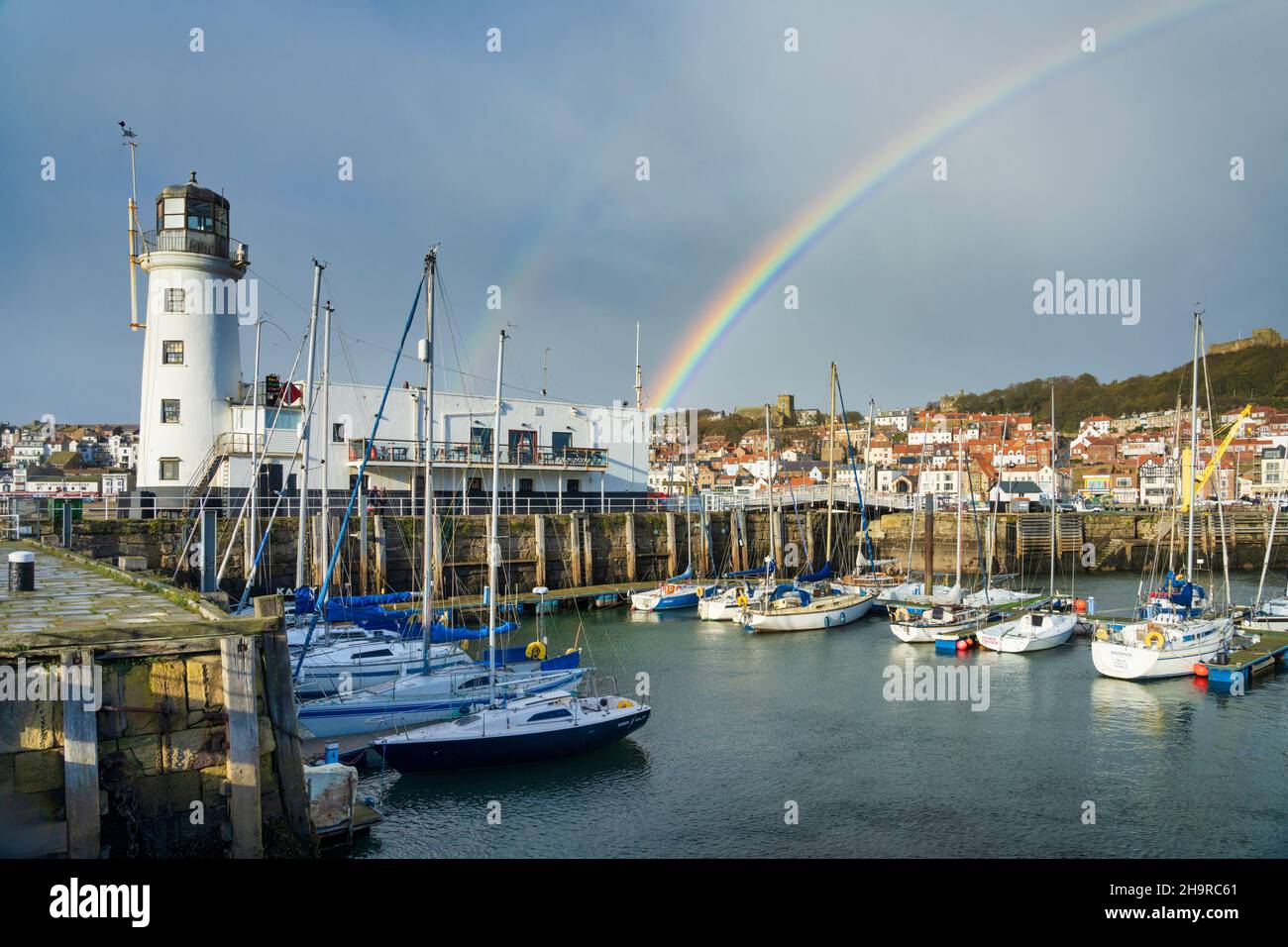 Autumn showers and a rainbow over Scarborough harbour, North Yorkshire UK Stock Photo